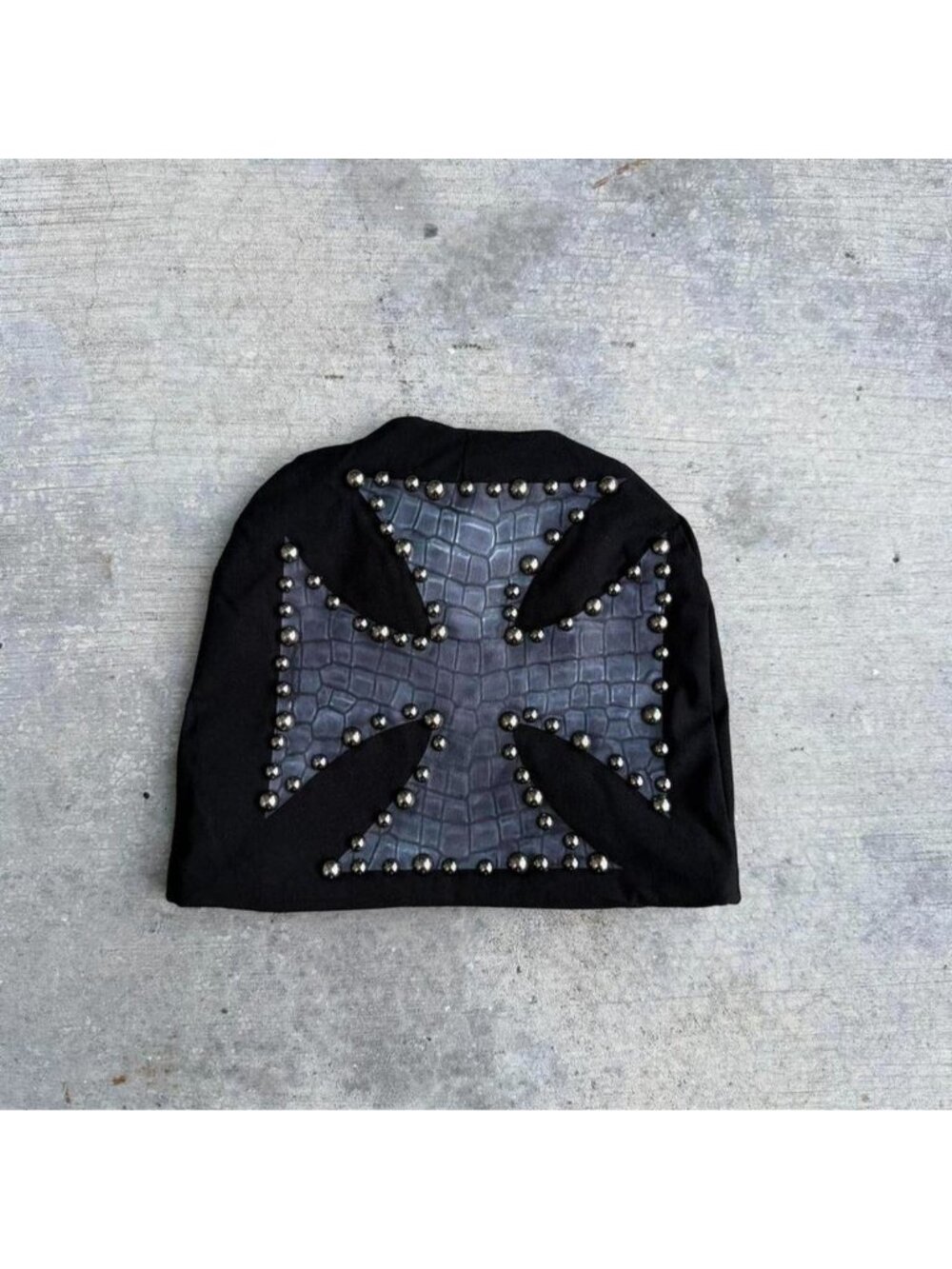Black beanie with a hard cross design and studs all around